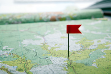 topographic map with colored flag pushpin close up
