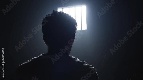a prisoner looking in the prison room window