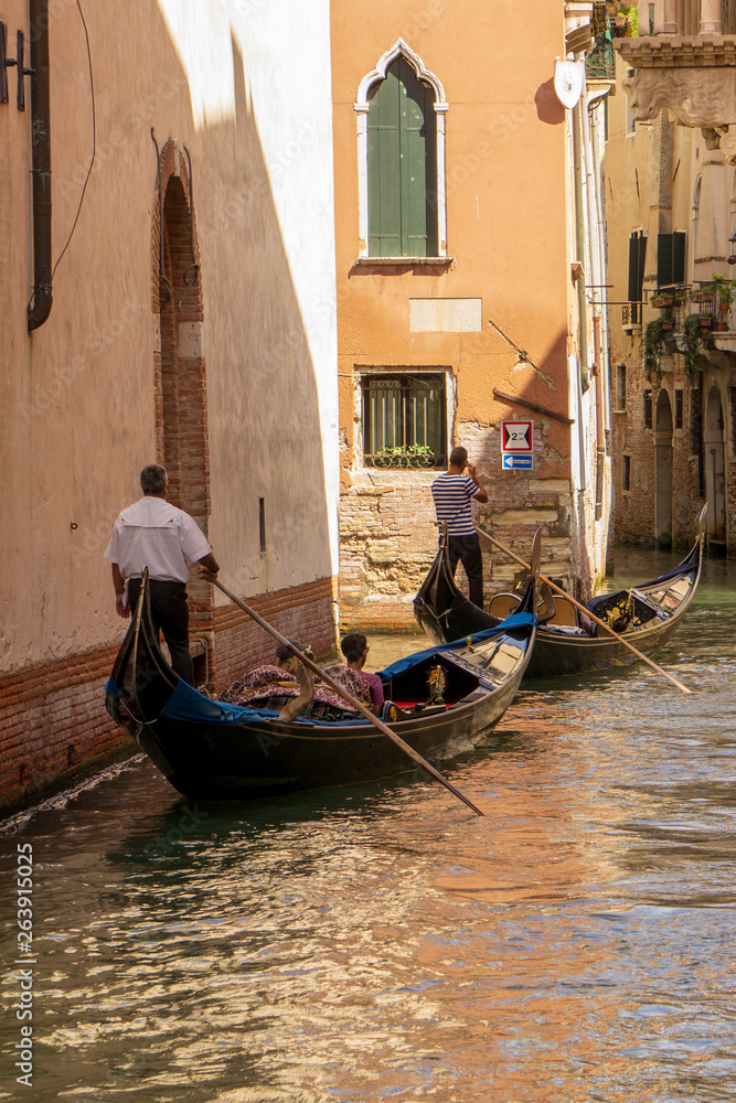 Venice, Italy - August/ 27/ 2018 -  Gondolas on canal in venice