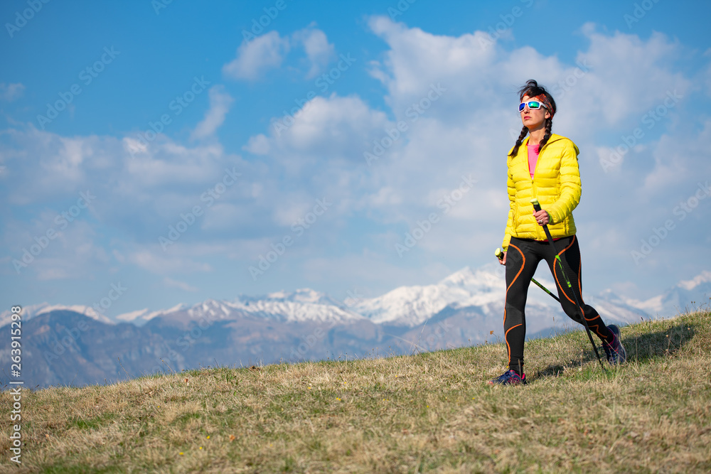 Girl with yellow down jacket strolls in the mountains Girl with yellow down jacket strolls in the mountains