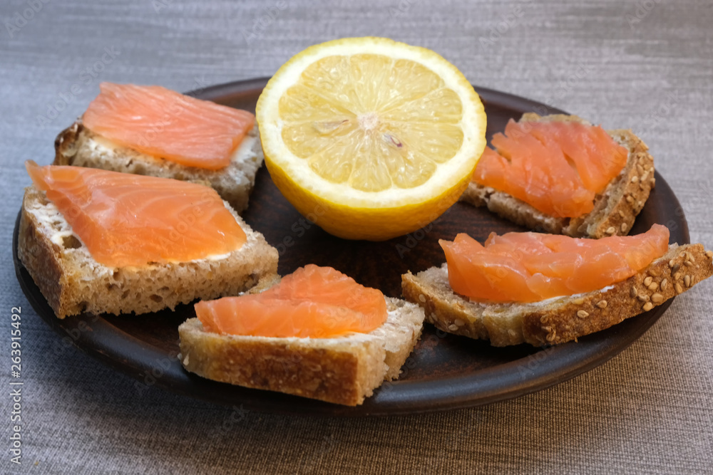 Small sandwiches on homemade bread with butter and red fish Small sandwiches on homemade bread with butter and red fish