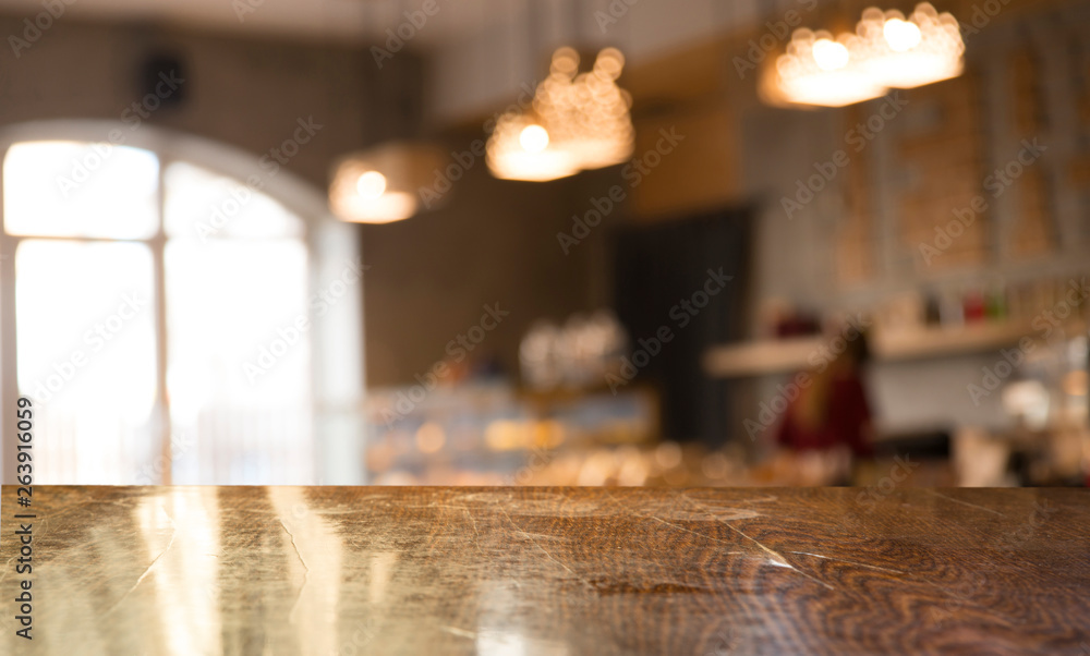Empty wooden table in front of abstract blurred background of coffee shop . can be used for display or montage your products.Mock up for display of product Empty wooden table in front of abstract blurred background of coffee shop . can be used for display or montage your products.Mock up for display of product