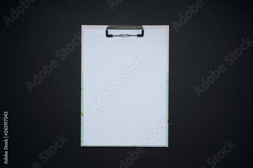 Blank white note board . Flat lay and top view with copy space on black background .