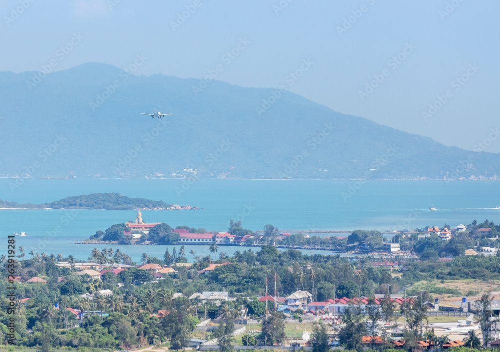 White commercial airplane landing over the sea into runway at Samui Airport, samui , Surat Thani, Thailand travel destinations concept.