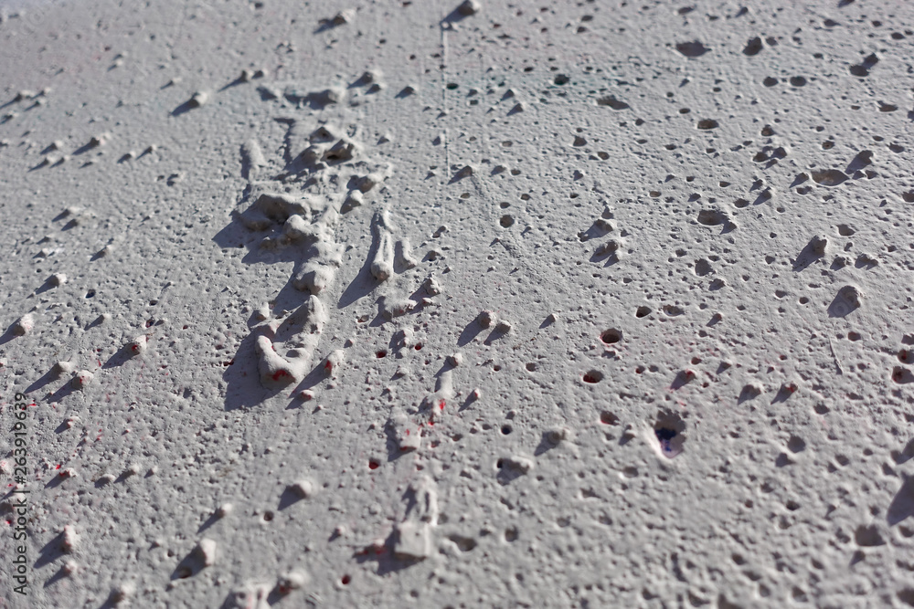 Rough uneven texture on a concrete wall. Gray background Rough uneven texture on a concrete wall. Gray background