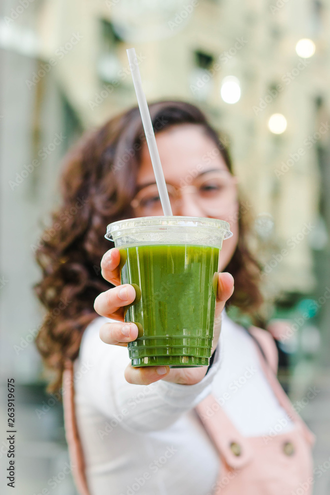 Fototapeta premium Girl with a takeaway plastic drink.