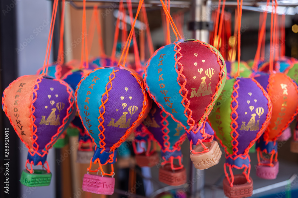 Many small colorful toy balloons hang as souvenirs for tourists. This is a good souvenir from Cappadocia, Turkey. 
