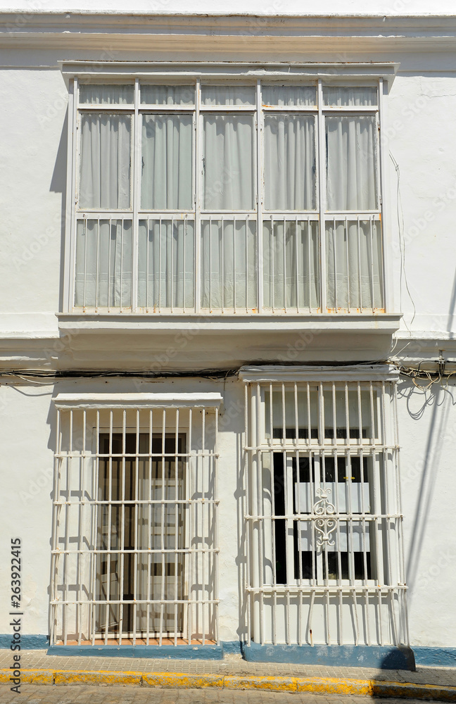 Obraz premium White house with iron bars typical architecture of San Fernando town in the province of Cadiz Andalusia Spain
