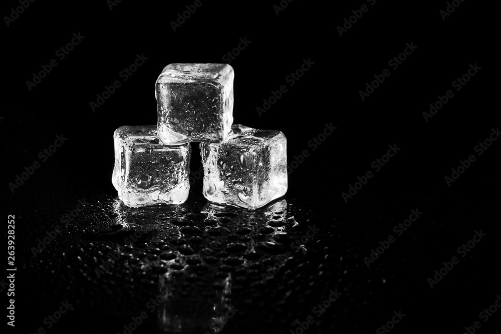 ice cubes reflection on black table background. ice cubes reflection on black table background.