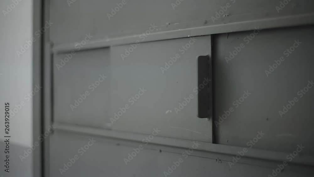 a prison cell door window open and close by hand a prison cell door window open and close by hand