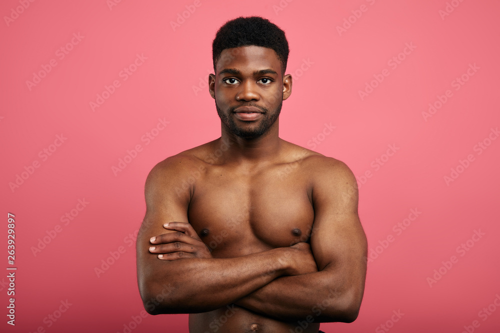 handsome awesome powerful confident man with crossed arms looking at the camera.fitness, beautiful body.confidence concept handsome awesome powerful confident man with crossed arms looking at the camera.fitness, beautiful body.confidence concept