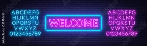 Neon sign welcome on on brick wall background. Neon alphabet.