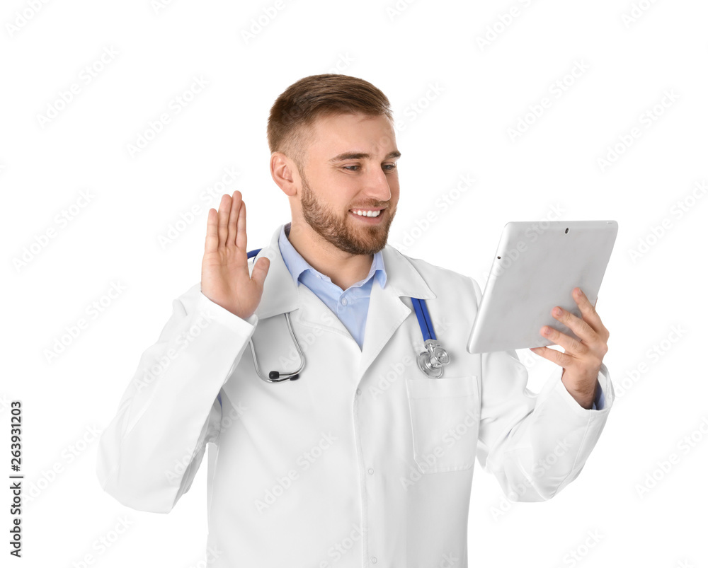 Male doctor using video chat on tablet against white background Male doctor using video chat on tablet against white background