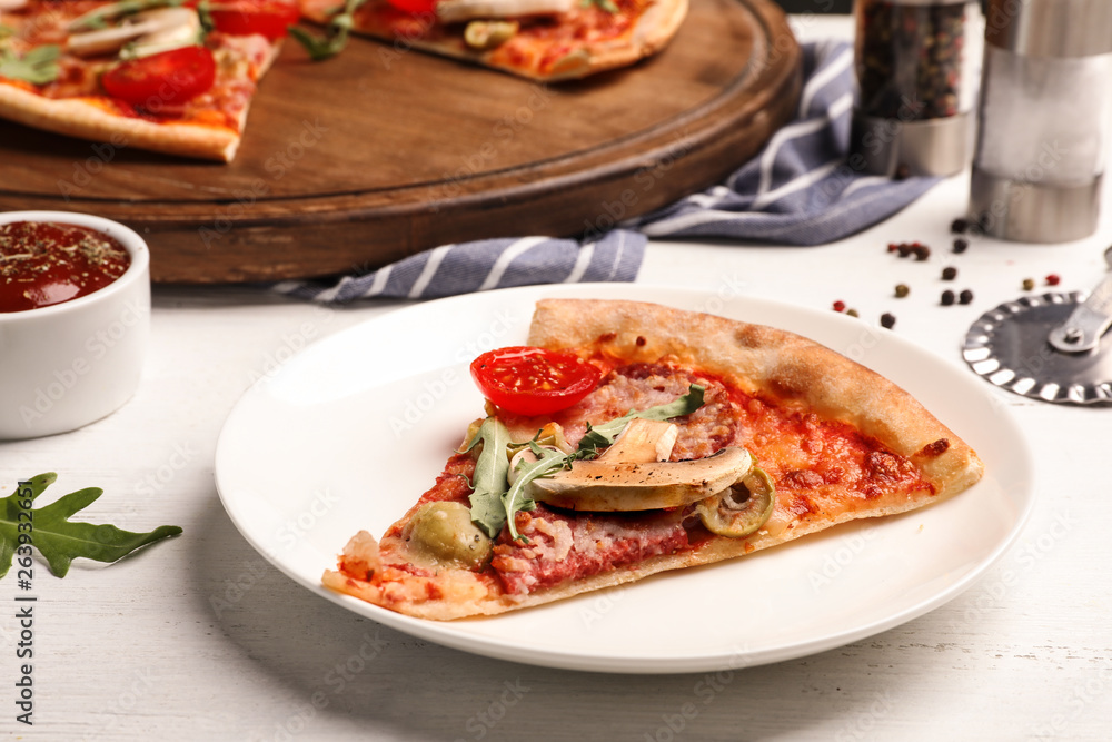 Plate with slice of delicious pizza baked in oven on table Plate with slice of delicious pizza baked in oven on table
