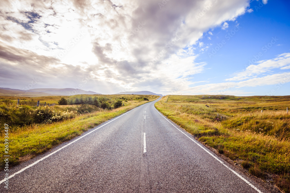 Trip or adventure: Abandoned, dramatic road in Scotland, cloudy sky. Trip or adventure: Abandoned, dramatic road in Scotland, cloudy sky.