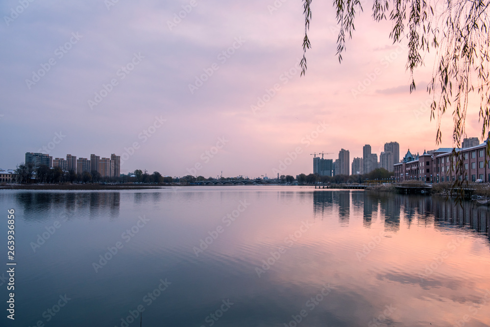 Fototapeta premium Skyline of Waterfront City under Sunset