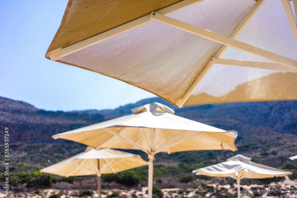 View at parasol and sunbeds at sea lagoon of Balos, Greece