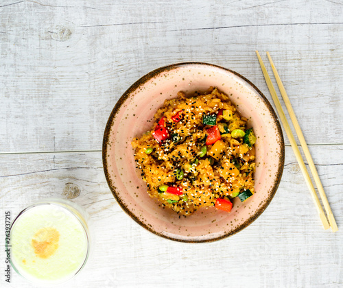 Tyahan - fried rice with chicken and vegetables in a bowl on the table photo