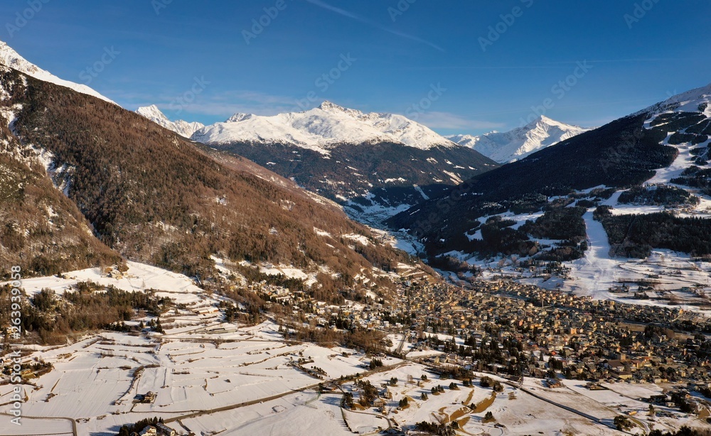 Bormio town with snowy mountains in background