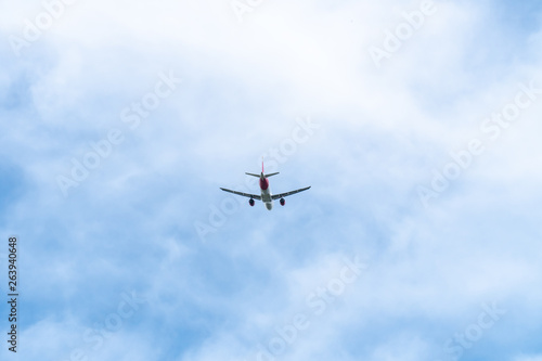 Passenger Airplane flying on cloudy sky