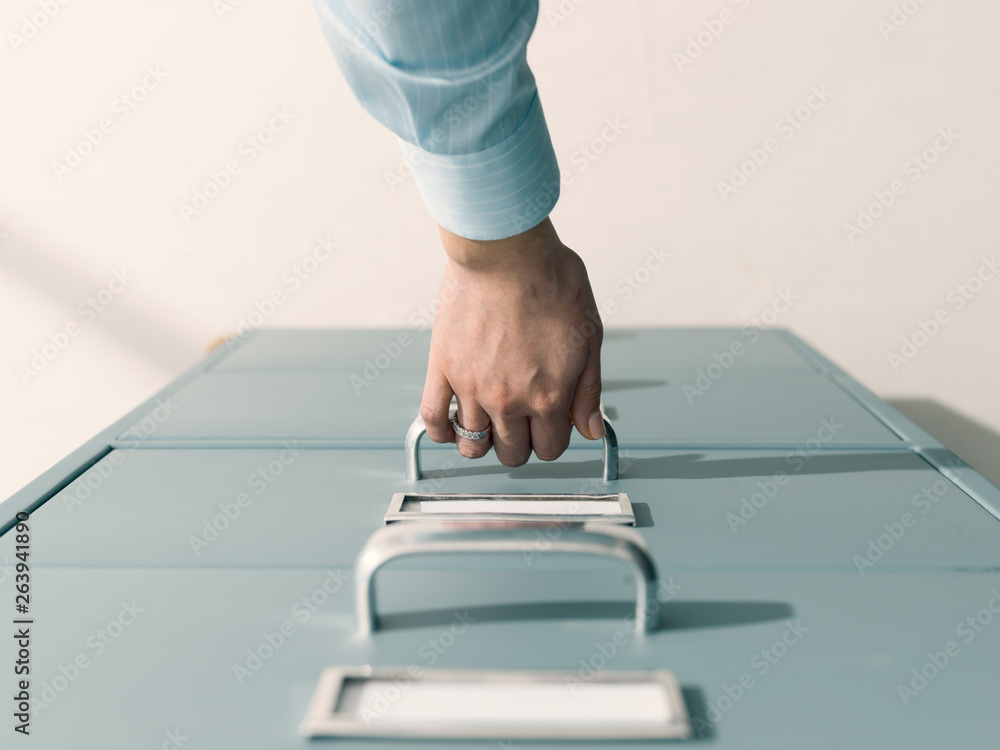 Secretary searching files in the filing cabinet Secretary searching files in the filing cabinet