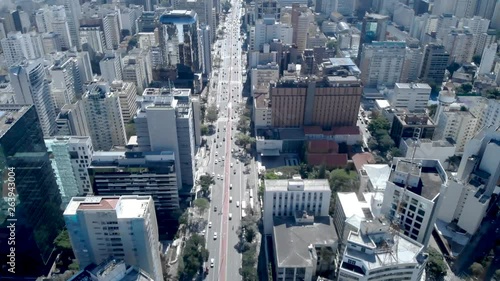 drone aerial recording of  Paulista avenue between buildings and transmission antennas photo