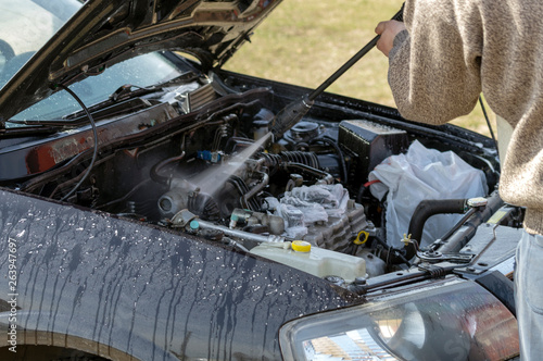 a man washes a car engine