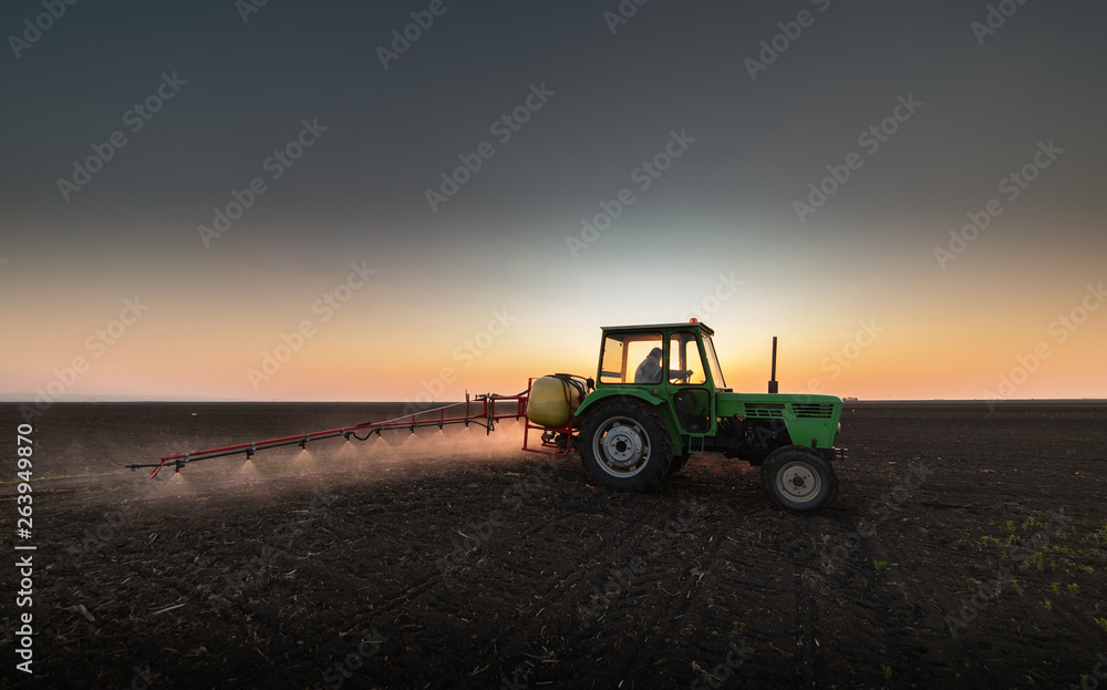 Tractor spraying pesticides at soy bean field Tractor spraying pesticides at soy bean field