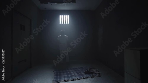 a prisoner looking in the prison room window