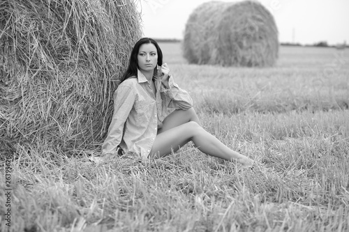 young free woman in a field with hay