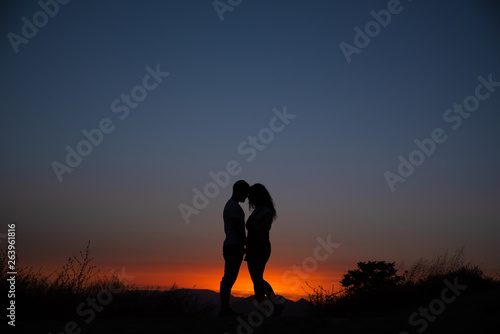 Young couple enjoying the sunset.