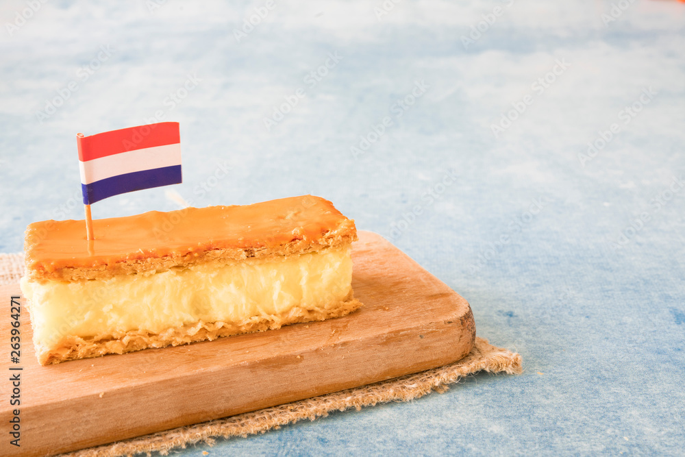 Orange tompouce, traditional Dutch treat with pudding and frosting on