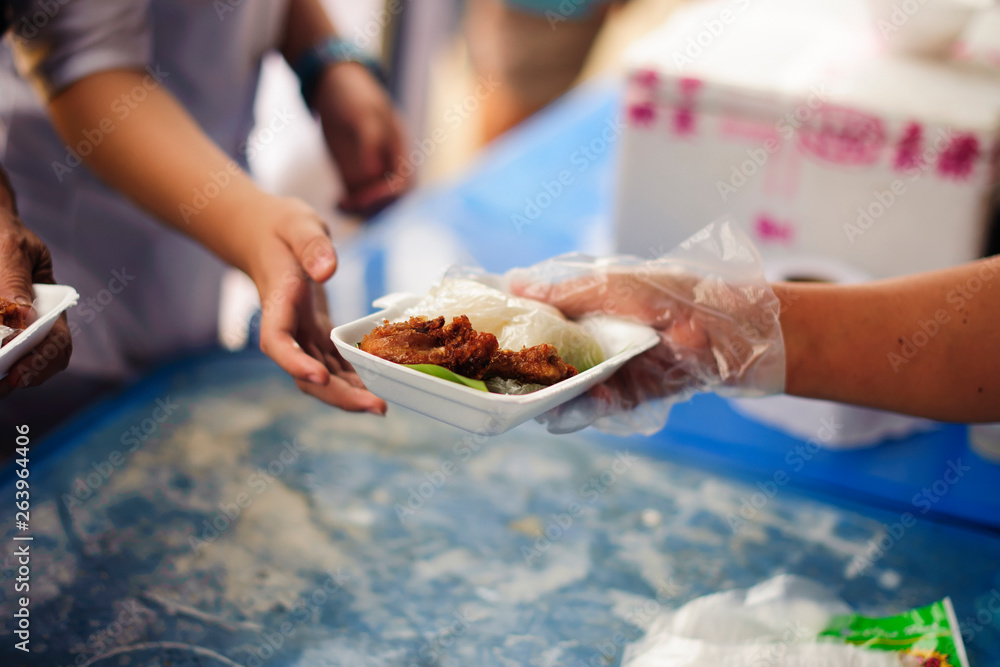 Volunteers provide food for beggars : Concepts Feeding and help : Concept of food sharing for the poor to alleviate hunger : Volunteers Share Food to the Poor
