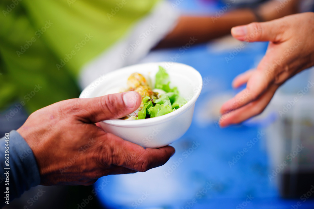 Volunteers provide food for beggars : Concepts Feeding and help : Concept of food sharing for the poor to alleviate hunger : Volunteers Share Food to the Poor Volunteers provide food for beggars : Concepts Feeding and help : Concept of food sharing for the poor to alleviate hunger : Volunteers Share Food to the Poor