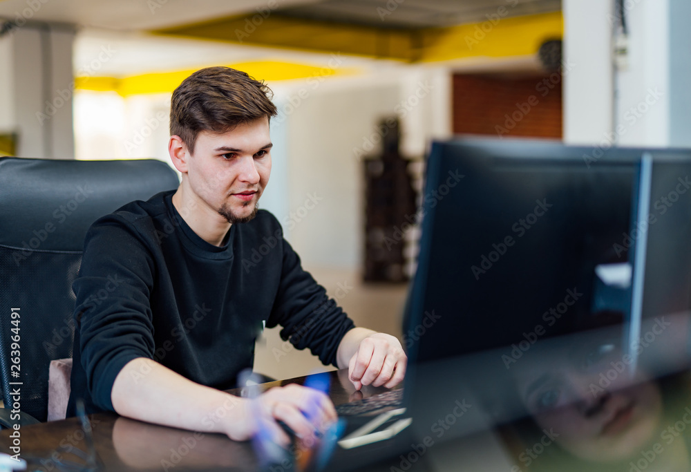 Young employee working at office desk Young employee working at office desk