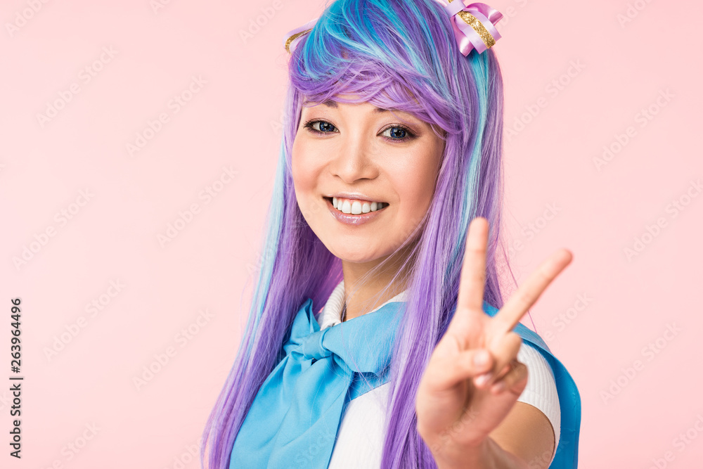 Blissful asian anime girl in purple wig showing peace sign isolated on pink  Stock Photo | Adobe Stock