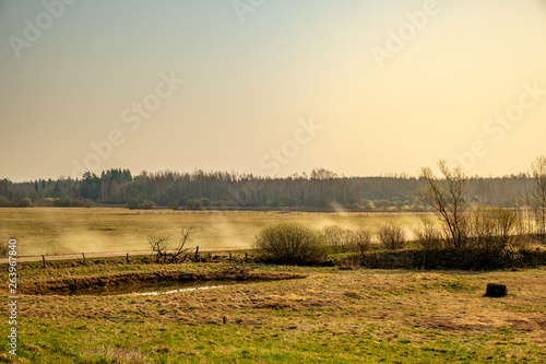 Fototapeta Naklejka Na Ścianę i Meble -  Countryside scene with fields pond and road 
