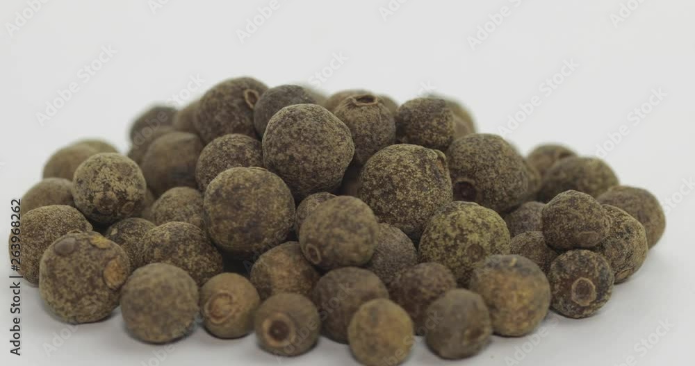 Black pepper rotation. Peas with spices. Macro on white background Black pepper rotation. Peas with spices. Macro on white background