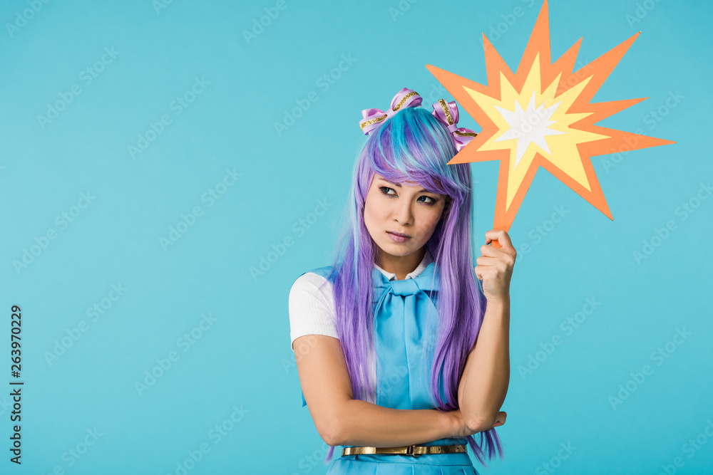 dissatisfied asian anime girl in wig looking away isolated on blue dissatisfied asian anime girl in wig looking away isolated on blue
