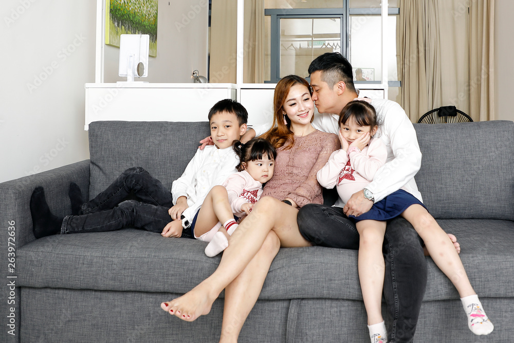 Parents Child Family father mother daughter son sit on sofa love affection happy Parents Child Family father mother daughter son sit on sofa love affection happy