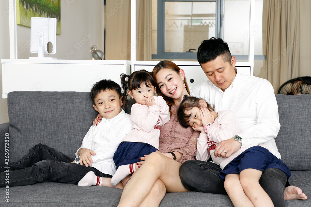 Parents Child Family father mother daughter son sit on sofa love affection happy Parents Child Family father mother daughter son sit on sofa love affection happy