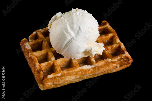 Belgium waffle with one ice cream scoop isolated on black background