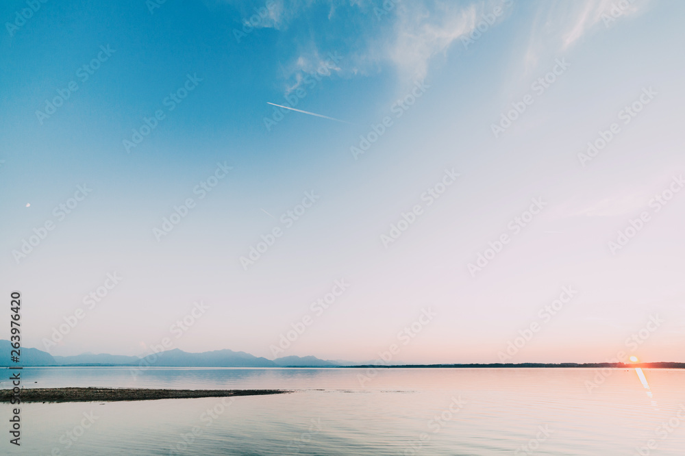 Amazing sunset in chiemsee lake with mountains in background
