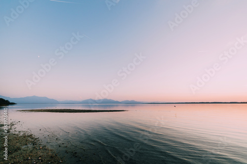 Fototapeta Naklejka Na Ścianę i Meble -  Amazing sunset in chiemsee lake with mountains in background