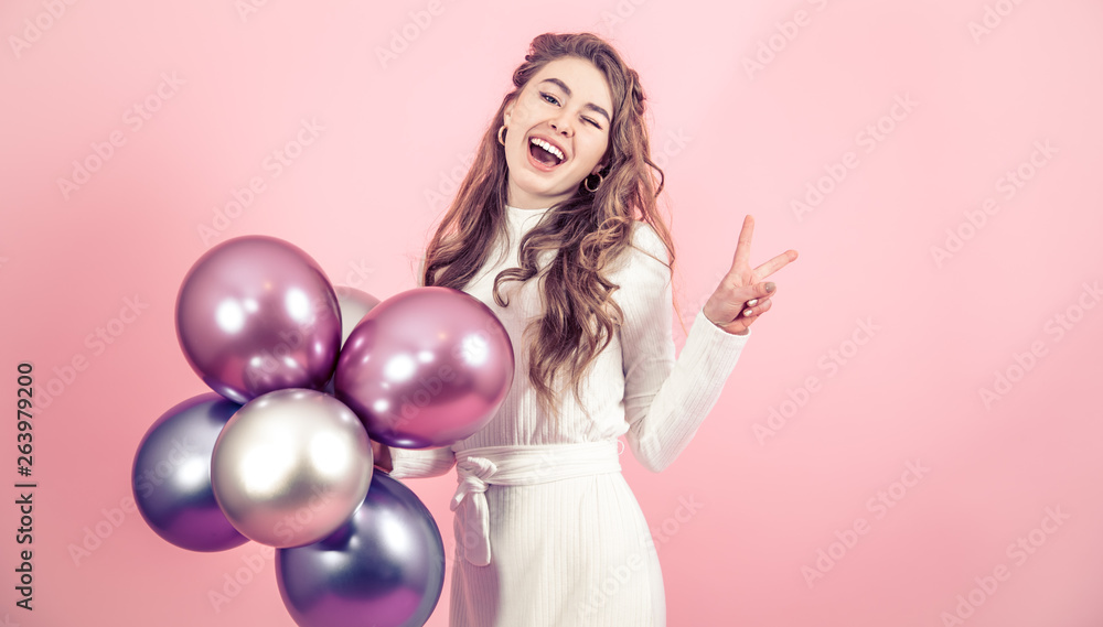 Young girl with balls on a colored background Young girl with balls on a colored background