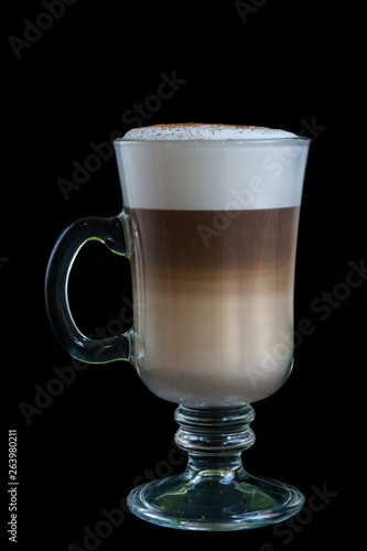 Special coffee in a nice glass cup isolated on black background