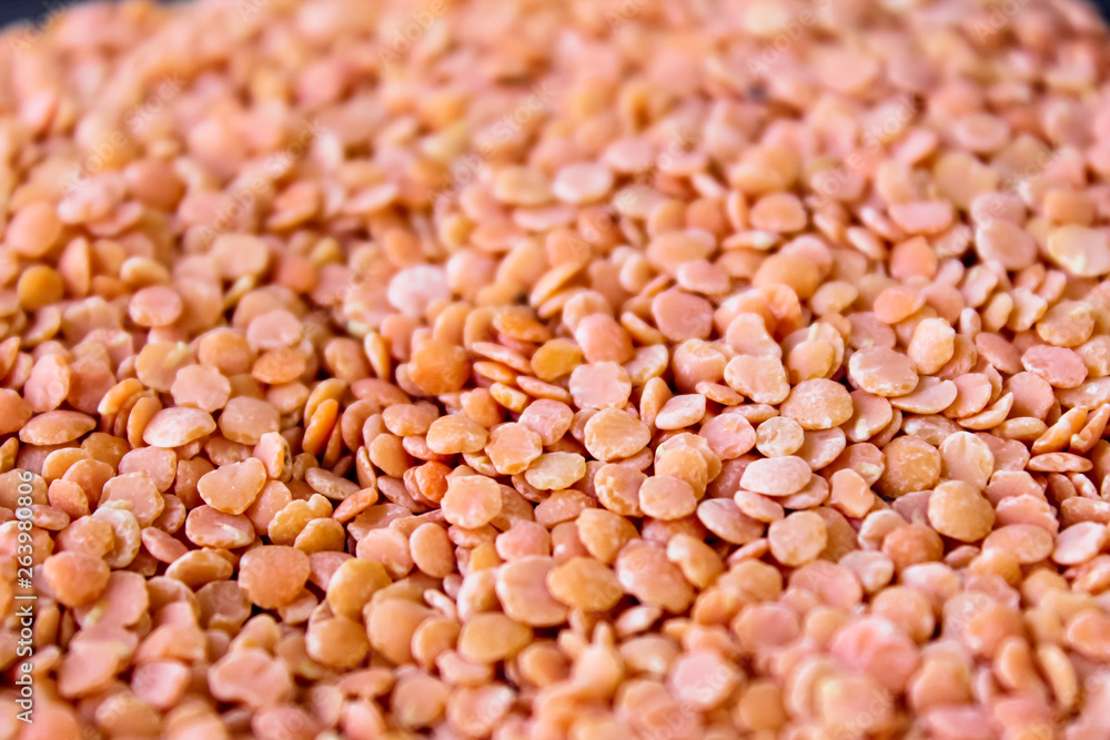 Red lentils in a box on a black background Red lentils in a box on a black background