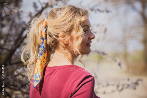 Fashionable trend. Portrait of young beautiful woman with  silk scarf inhair  