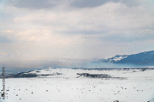Winter landscape of snowy anf foggy mountains in Turkey