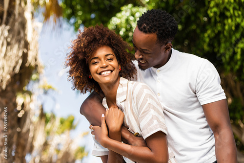 Outdoor protrait of black african american couple embracing each other photo